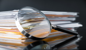 Magnifying glass on paperwork