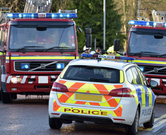 Two fire engines and police car at incident