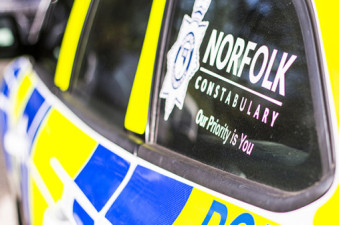 Side of police car with Norfolk Constabulary logo