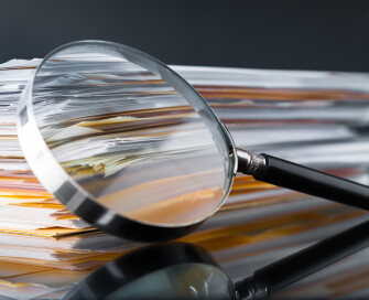 Magnifying glass on paperwork