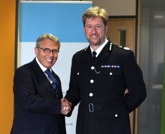 Former PCC Lorne Green shaking hands with former Chief Constable Simon Bailey