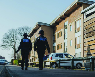 Male and female officer walking the beat in Norfolk CMYK