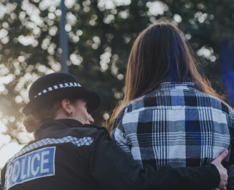 Police officer comforting a victim of crime