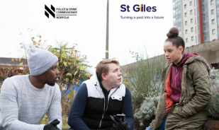 Three young people talking in a group outside