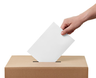 Vote being placed in a ballot box