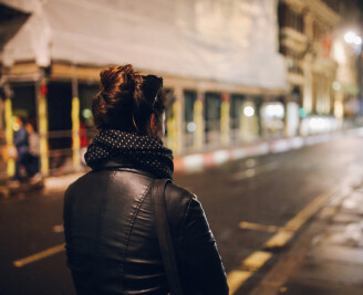 Woman alone in street at night