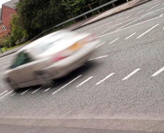 Blurred image of car speeding along road