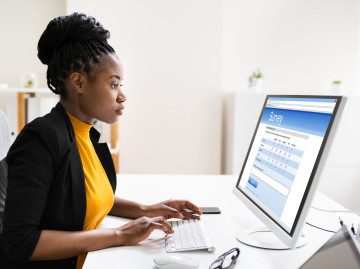 Woman taking survey on laptop