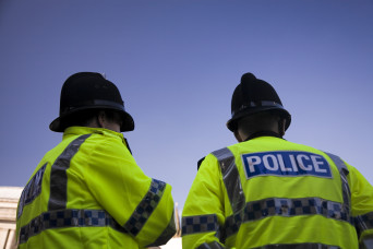 the back of two officers wearing high visibility jackets