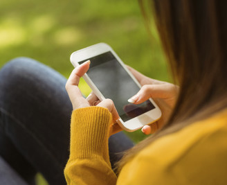 younger female using mobile phone