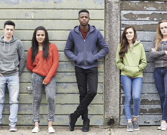 Five young people standing in a line