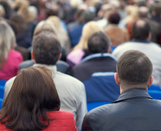 Backs of people at a meeting