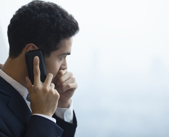 Man in suit holding mobile phone to ear