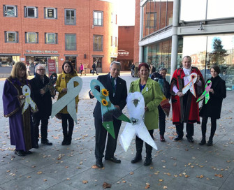 Former PCC Lorne Green standing with partners outside The Forum Norwich at launch of White Ribbon campaign
