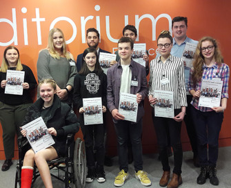 Group shot of Youth Commissioners holding copies of their report