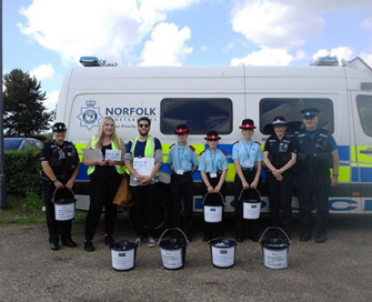 Group of Youth Commissioners standing in front of police van at Norfolk Show