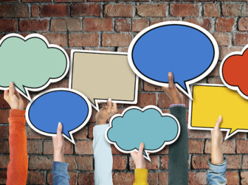 Arms holding speech bubbles in the air