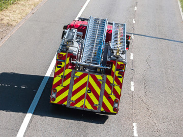 Back of fire engine driving along road